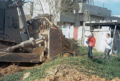 Rachel Corrie attempting to block the bulldozwer before it killed her